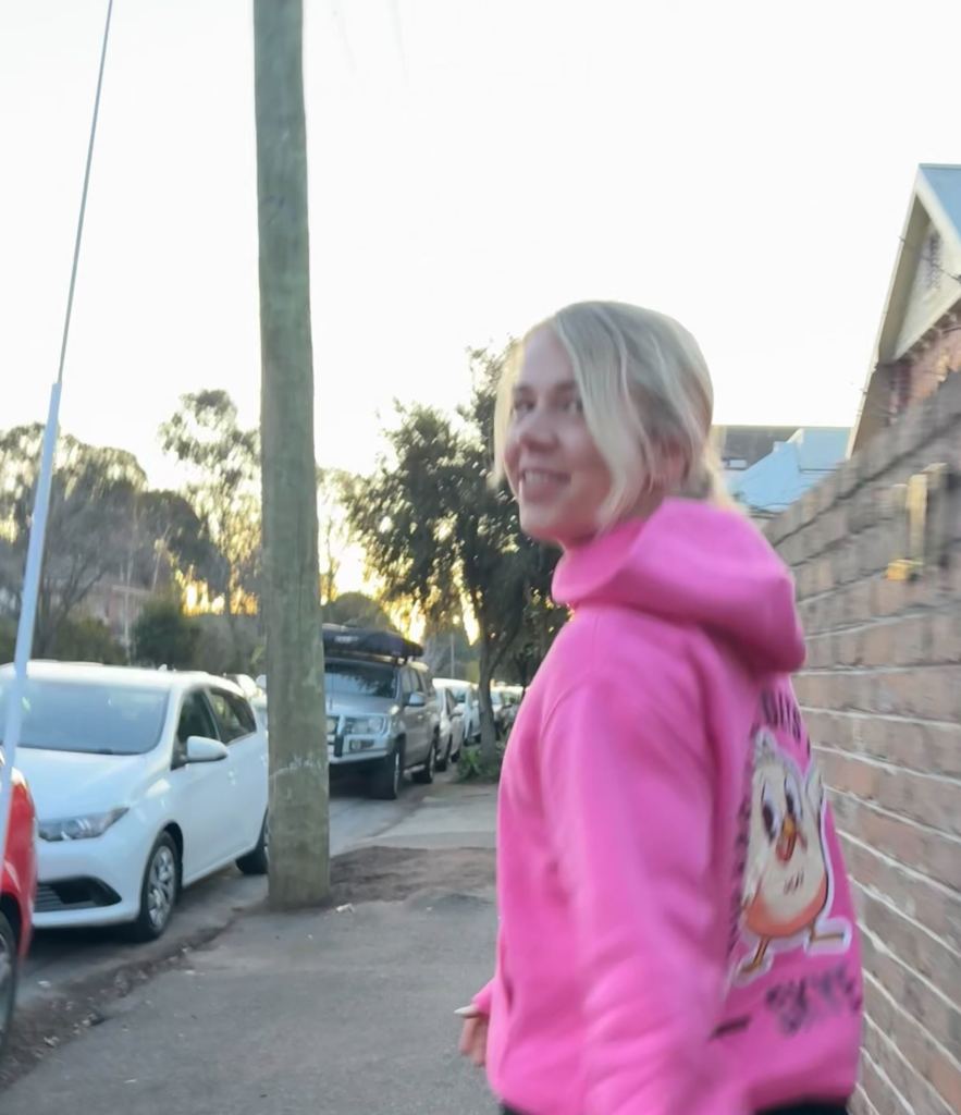Sunrise Run Leader Skye wearing the Sunrise Merch hoodie in Brunswick. 